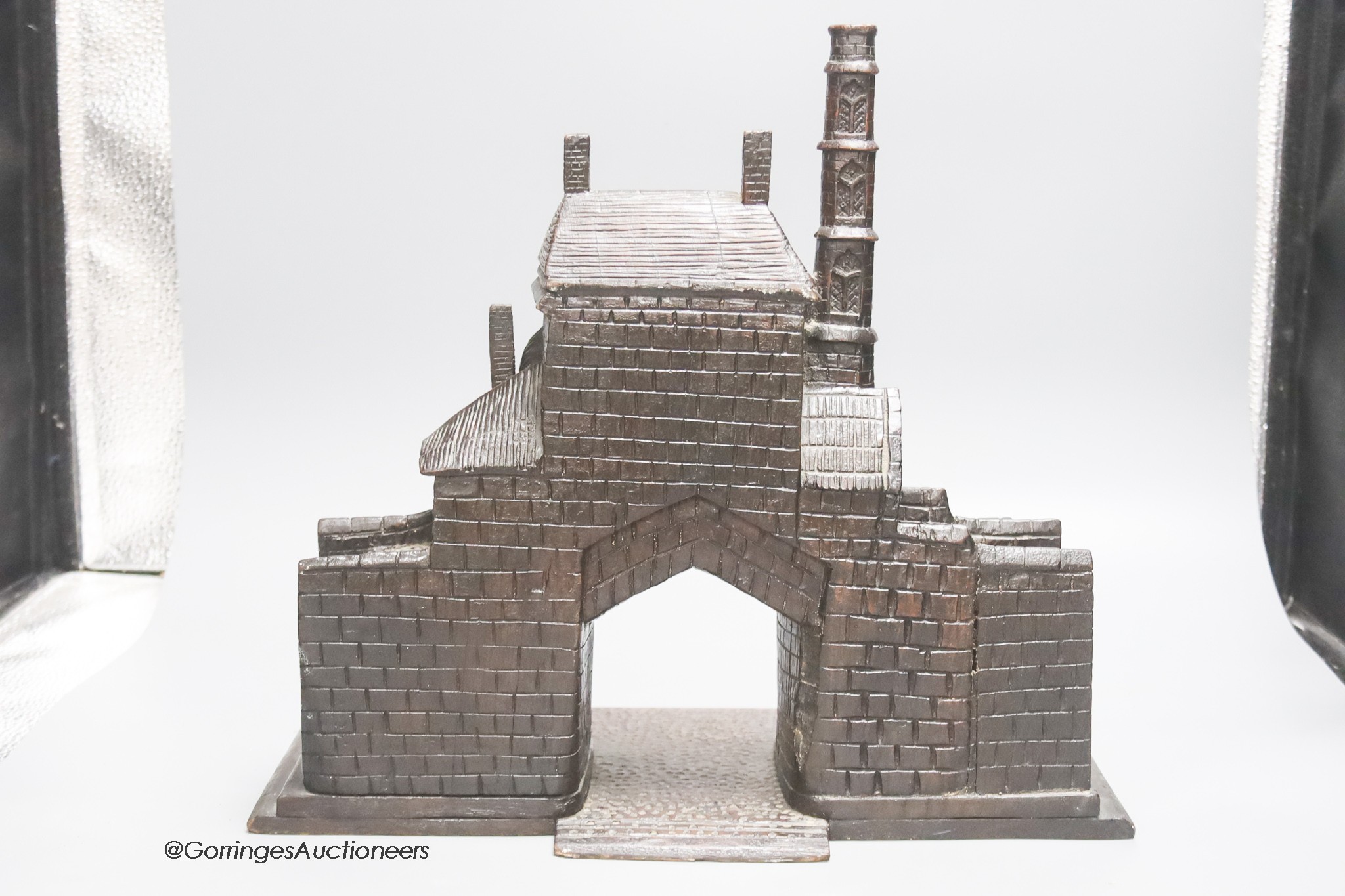 A 19th century carved oak model of a medieval Gatehouse, stamped A. Cotgreave, and inscribed 1774, width 37cm height 34cm